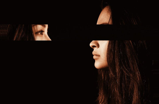 How Could I Have Missed This? woman's face looking at herself